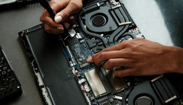 a-person-working-on-a-laptop-with-a-screwdriver.jpg A person working on a laptop with a screwdriver