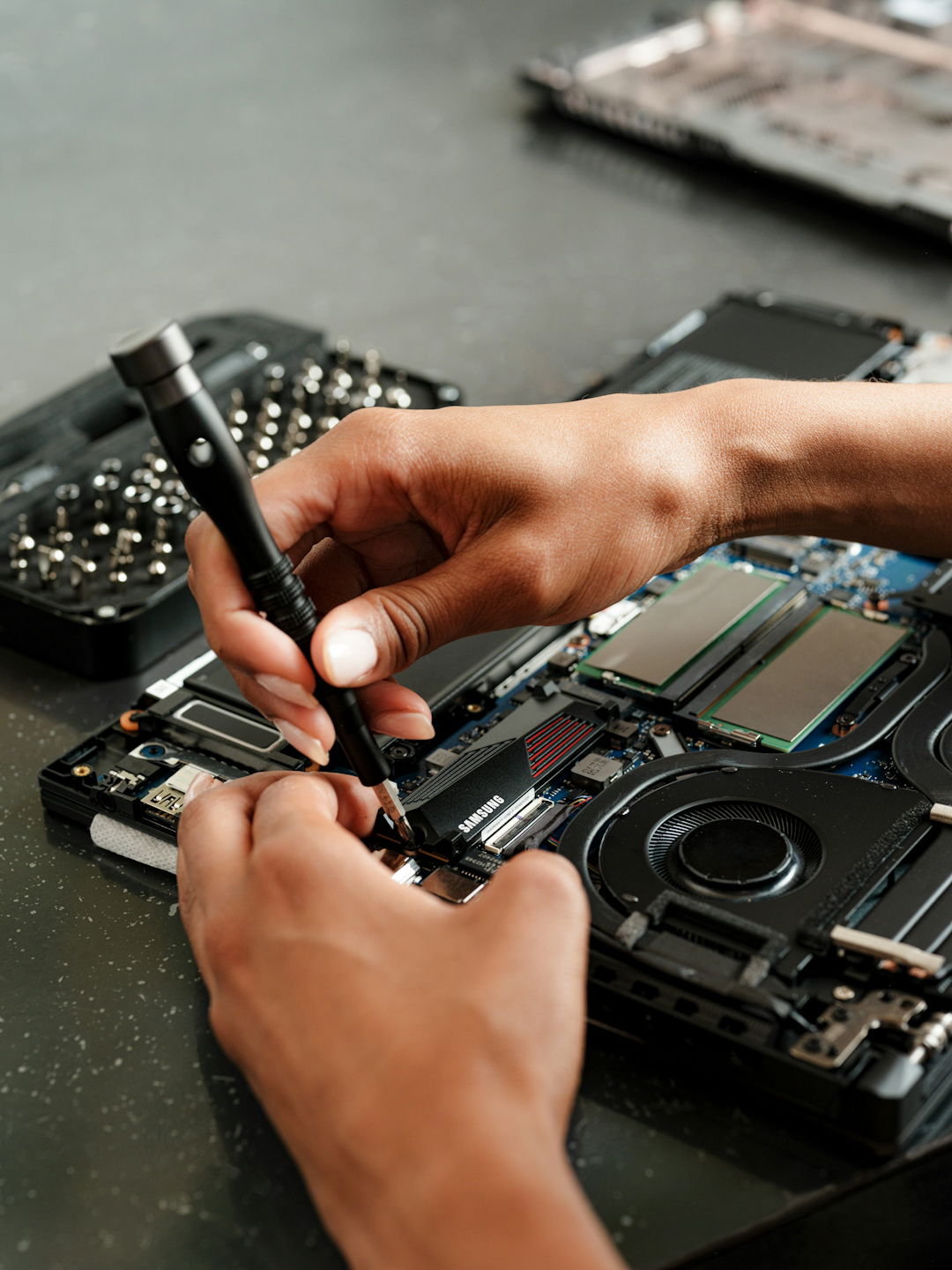 a-person-is-working-on-a-piece-of-electronics.jpg A person is working on a piece of electronics